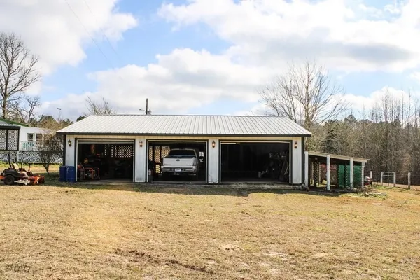 a view of a house with a yard and covered with snow