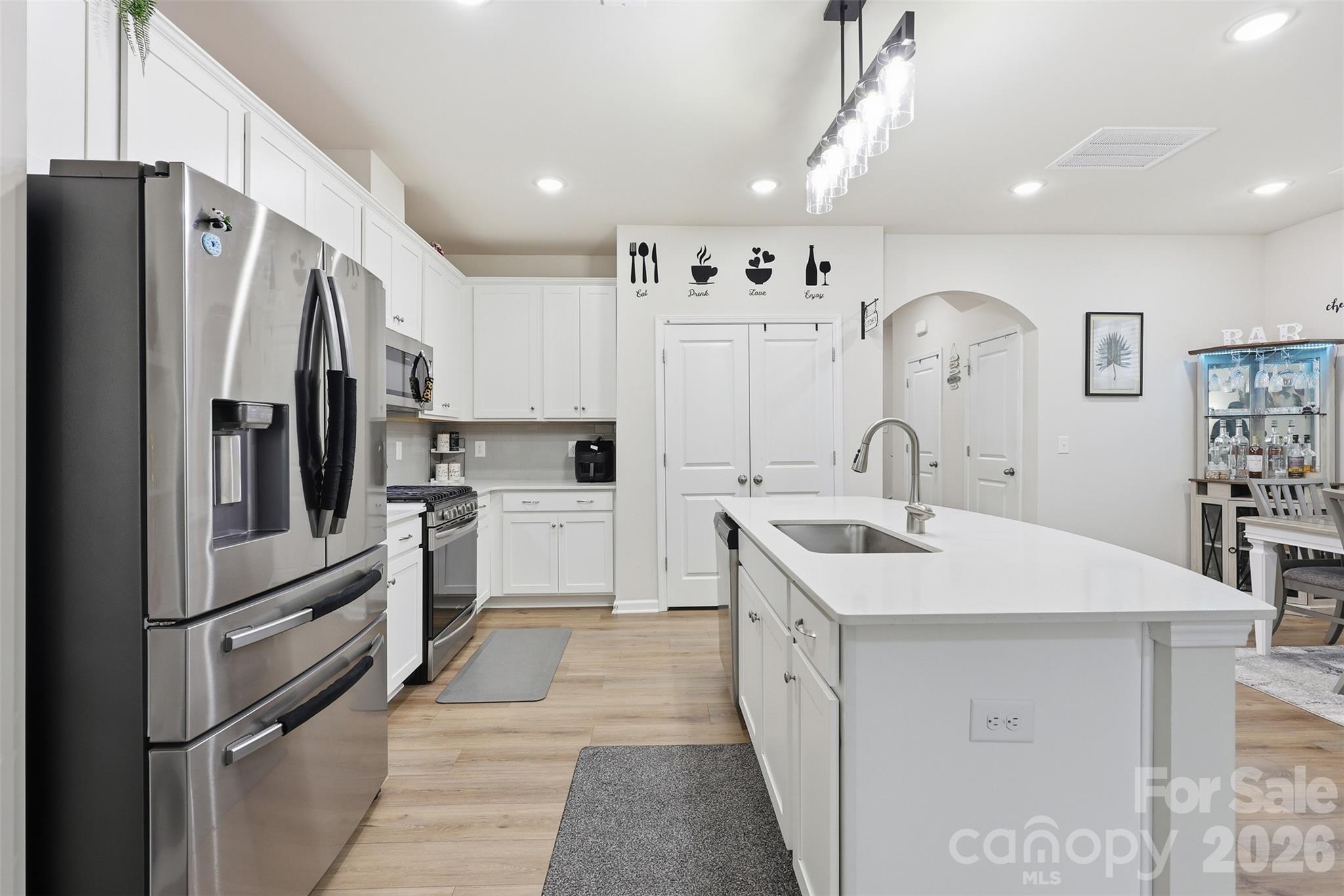 6029 Chelsea Oaks Ridge Fort Mill, SC 29708 - Photo 11 of 33 a kitchen with white cabinets and stainless steel appliances