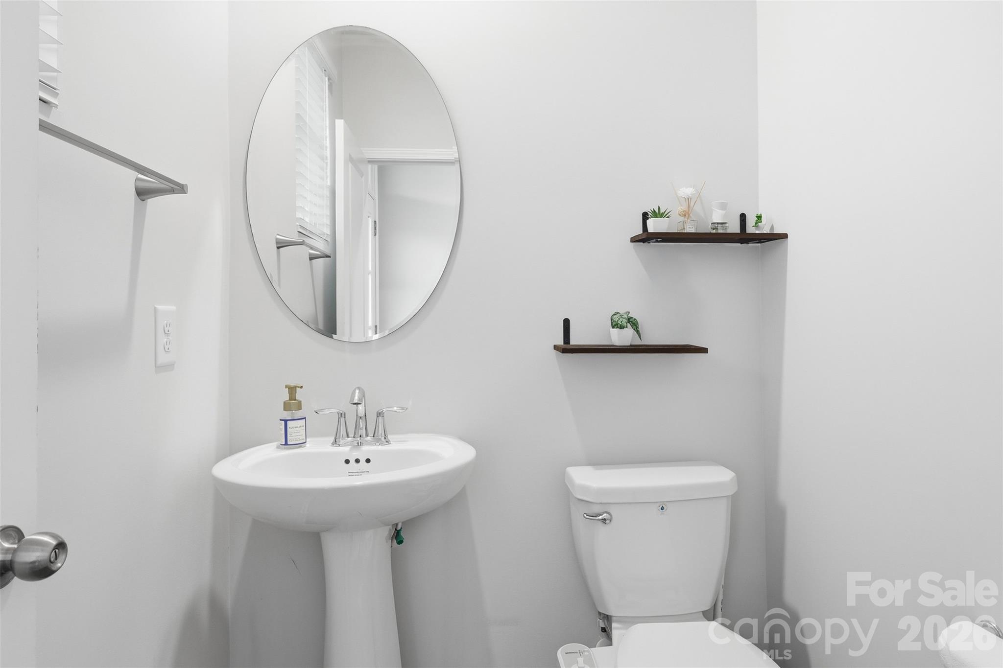 6029 Chelsea Oaks Ridge Fort Mill, SC 29708 - Photo 16 of 33 a bathroom with a toilet sink and mirror