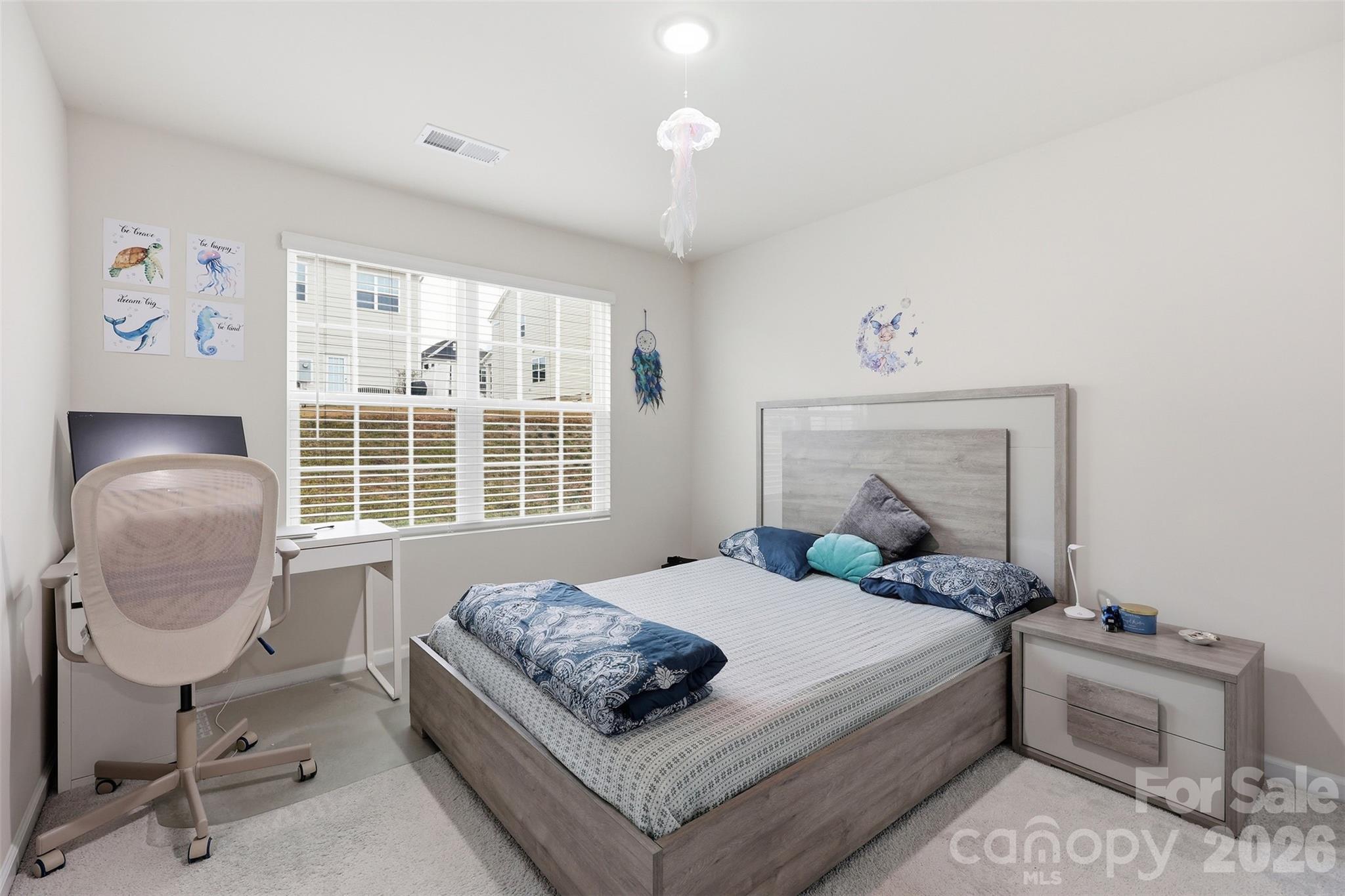 6029 Chelsea Oaks Ridge Fort Mill, SC 29708 - Photo 22 of 33 a bedroom with a bed and a chair