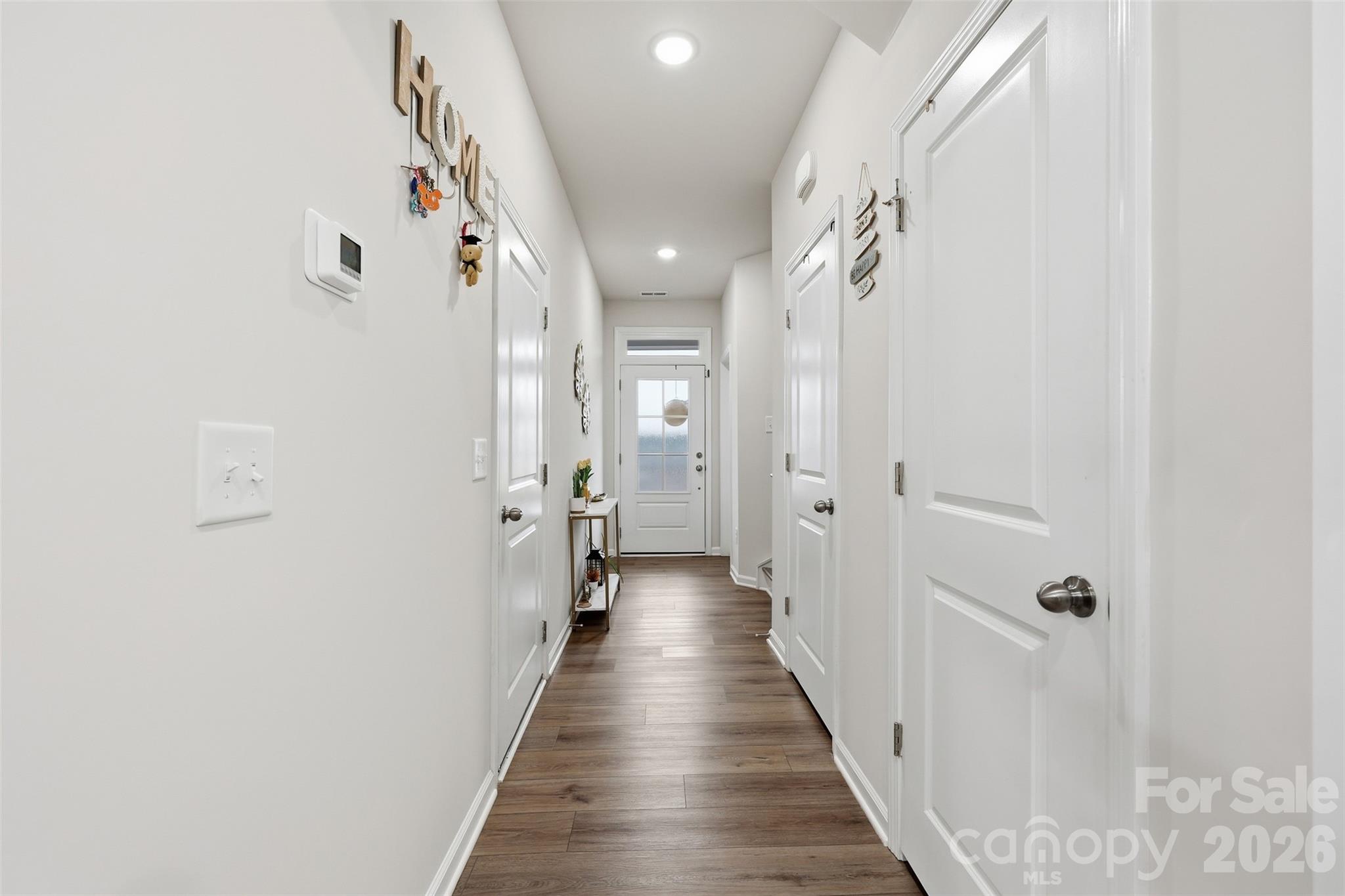 6029 Chelsea Oaks Ridge Fort Mill, SC 29708 - Photo 3 of 33 a view of a hallway with wooden floor and a bathroom
