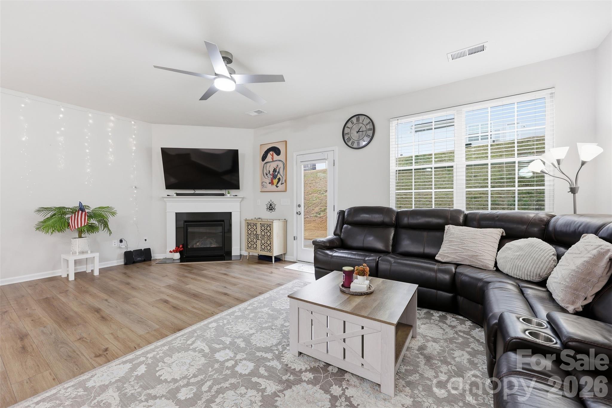 6029 Chelsea Oaks Ridge Fort Mill, SC 29708 - Photo 4 of 33 a living room with furniture a fireplace and a flat screen tv