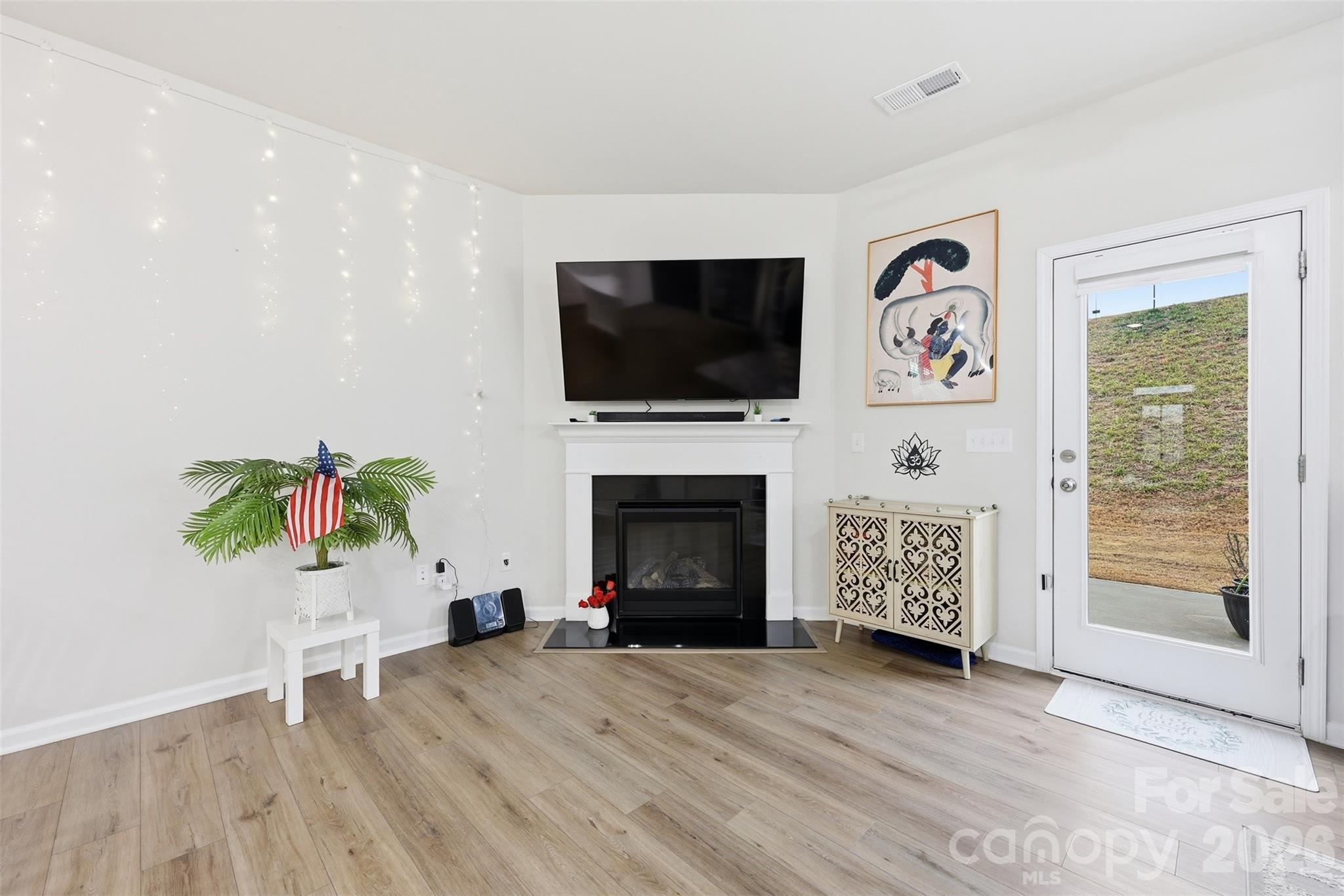 6029 Chelsea Oaks Ridge Fort Mill, SC 29708 - Photo 7 of 33 a living room with furniture a flat screen tv and a fireplace