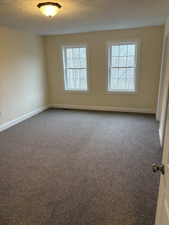 168 Main Street, Unit 1 Boylston, MA 01505 - Photo 12 of 24 an empty room with windows