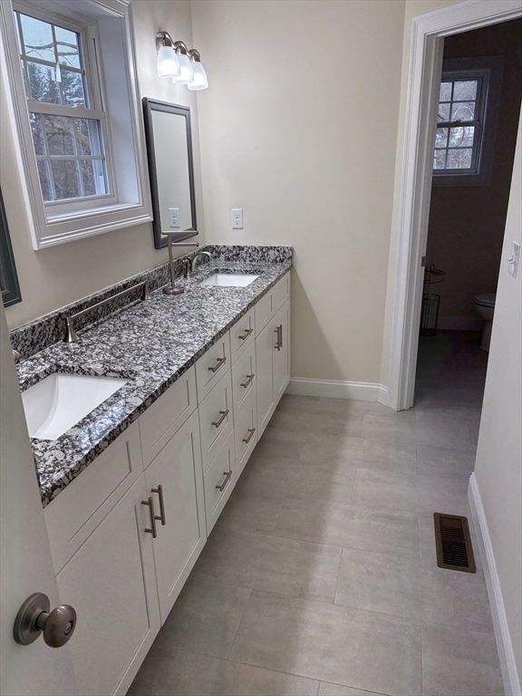 168 Main Street, Unit 1 Boylston, MA 01505 - Photo 15 of 24 a bathroom with a granite countertop sink and a mirror