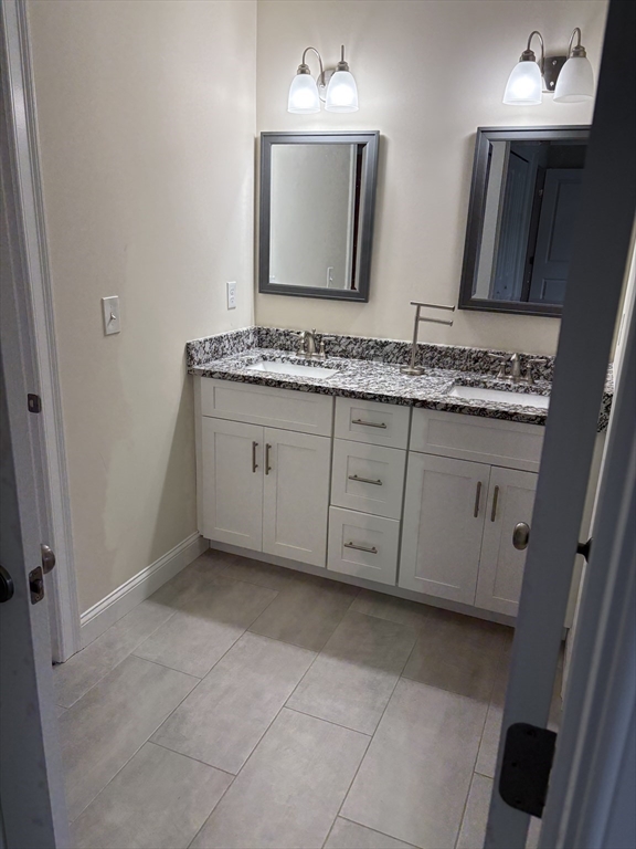 168 Main Street, Unit 1 Boylston, MA 01505 - Photo 20 of 24 a bathroom with a sink and a mirror