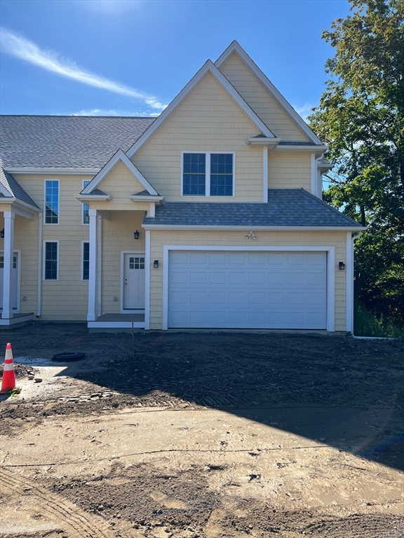 168 Main Street, Unit 1 Boylston, MA 01505 - Photo 2 of 24 a front view of a house with a yard