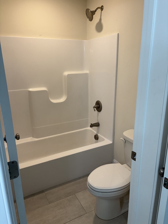 168 Main Street, Unit 1 Boylston, MA 01505 - Photo 21 of 24 a bathroom with a toilet and a bath tub