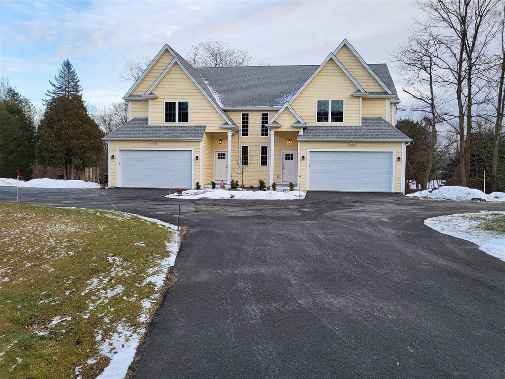 168 Main Street, Unit 1 Boylston, MA 01505 - Photo 24 of 24 a view of a house with a yard and garage