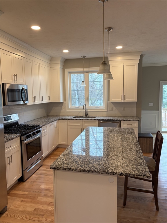 168 Main Street, Unit 1 Boylston, MA 01505 - Photo 5 of 24 a kitchen with granite countertop a sink a counter top space appliances and cabinets