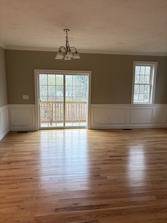 168 Main Street, Unit 1 Boylston, MA 01505 - Photo 7 of 24 a view of an empty room with wooden floor and a window