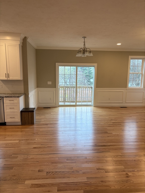 168 Main Street, Unit 1 Boylston, MA 01505 - Photo 9 of 24 a view of empty room with wooden floor and fan
