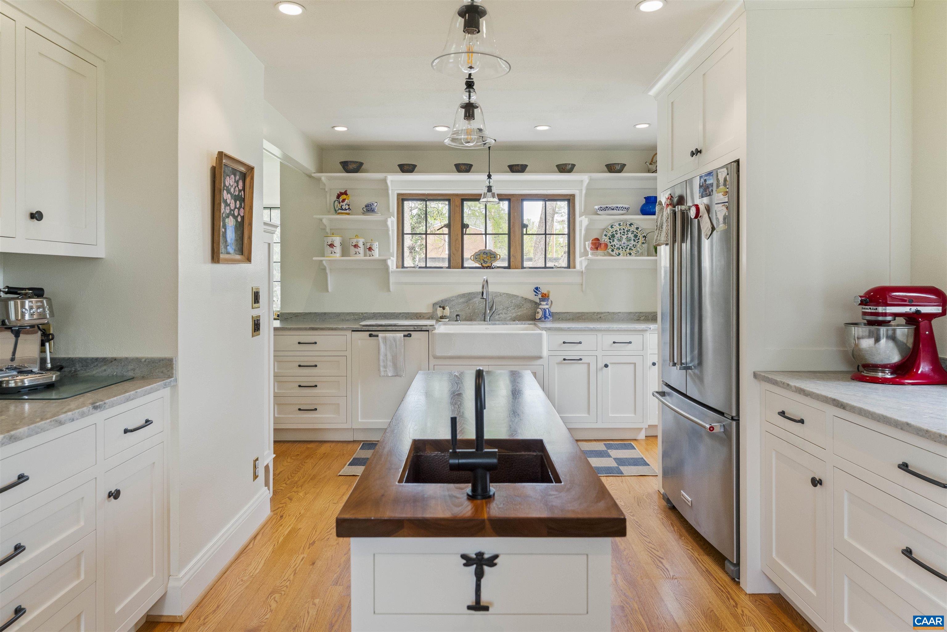 1917 Thomson Road Charlottesville, VA 22903 - Photo 12 of 45 a kitchen with stainless steel appliances a dining table chairs stove and cabinets