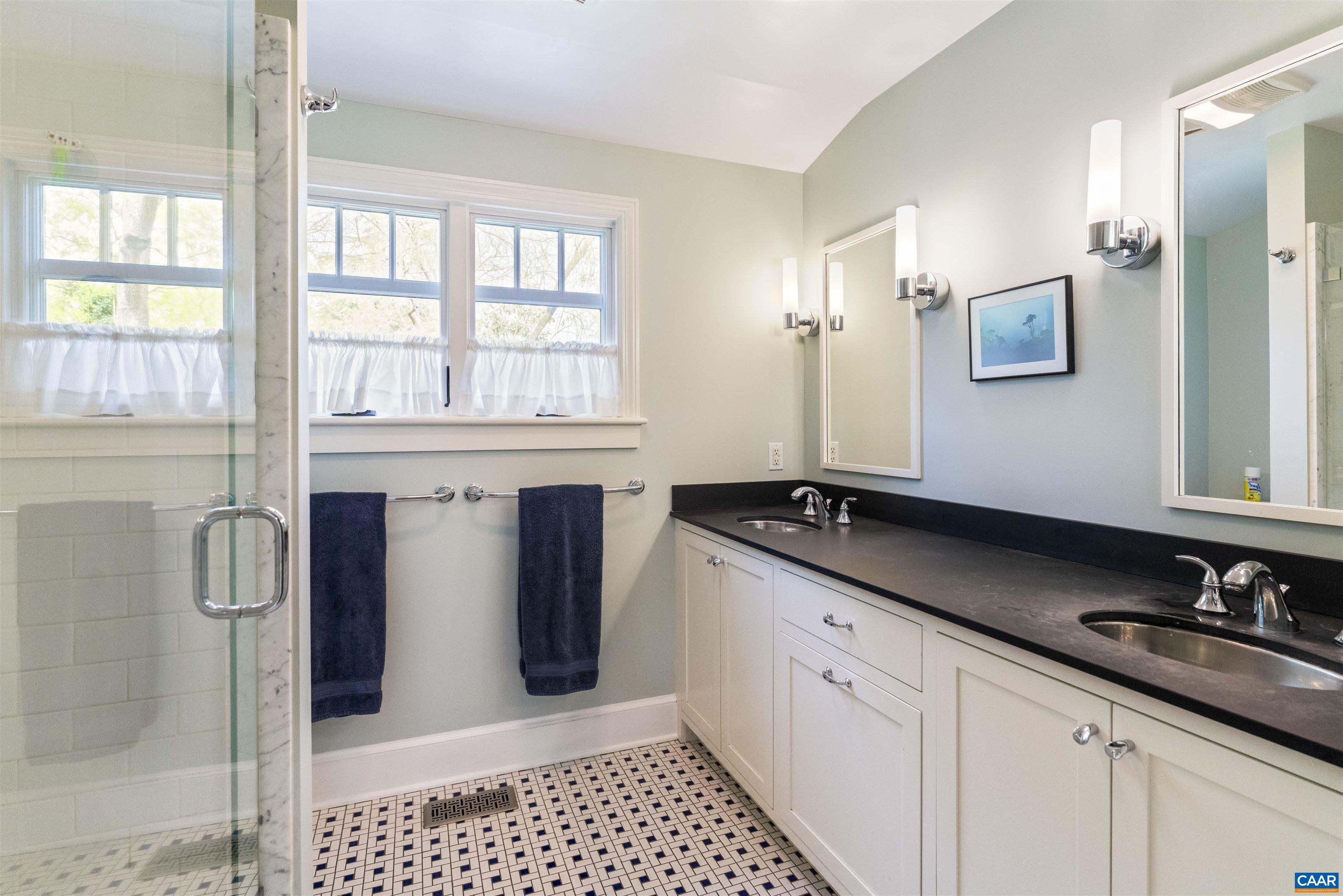 1917 Thomson Road Charlottesville, VA 22903 - Photo 36 of 45 a bath room with a sink and a large mirror
