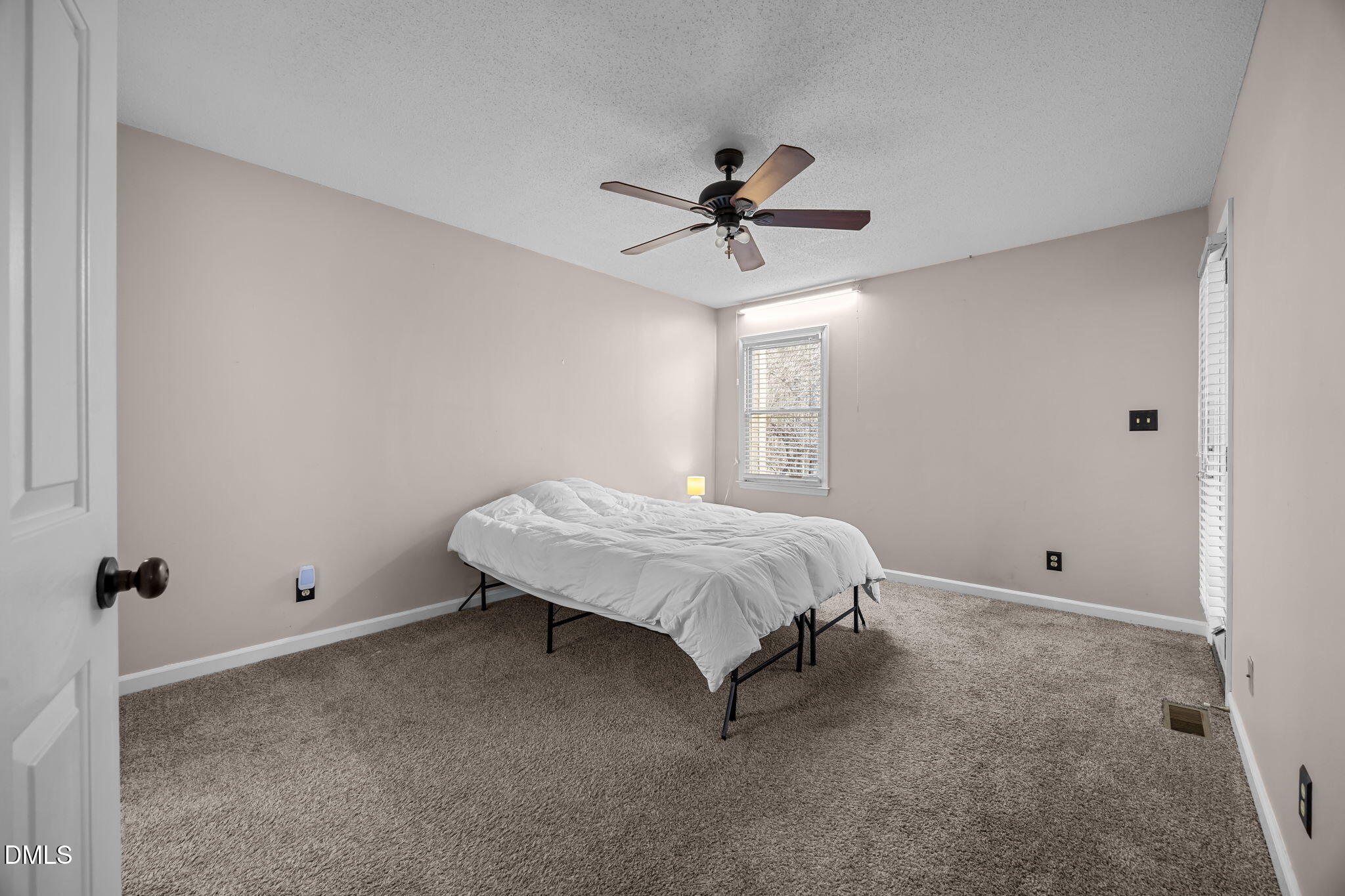 135 Boldleaf Court Cary, NC 27513 - Photo 14 of 34 a spacious bedroom with a bed and a chandelier