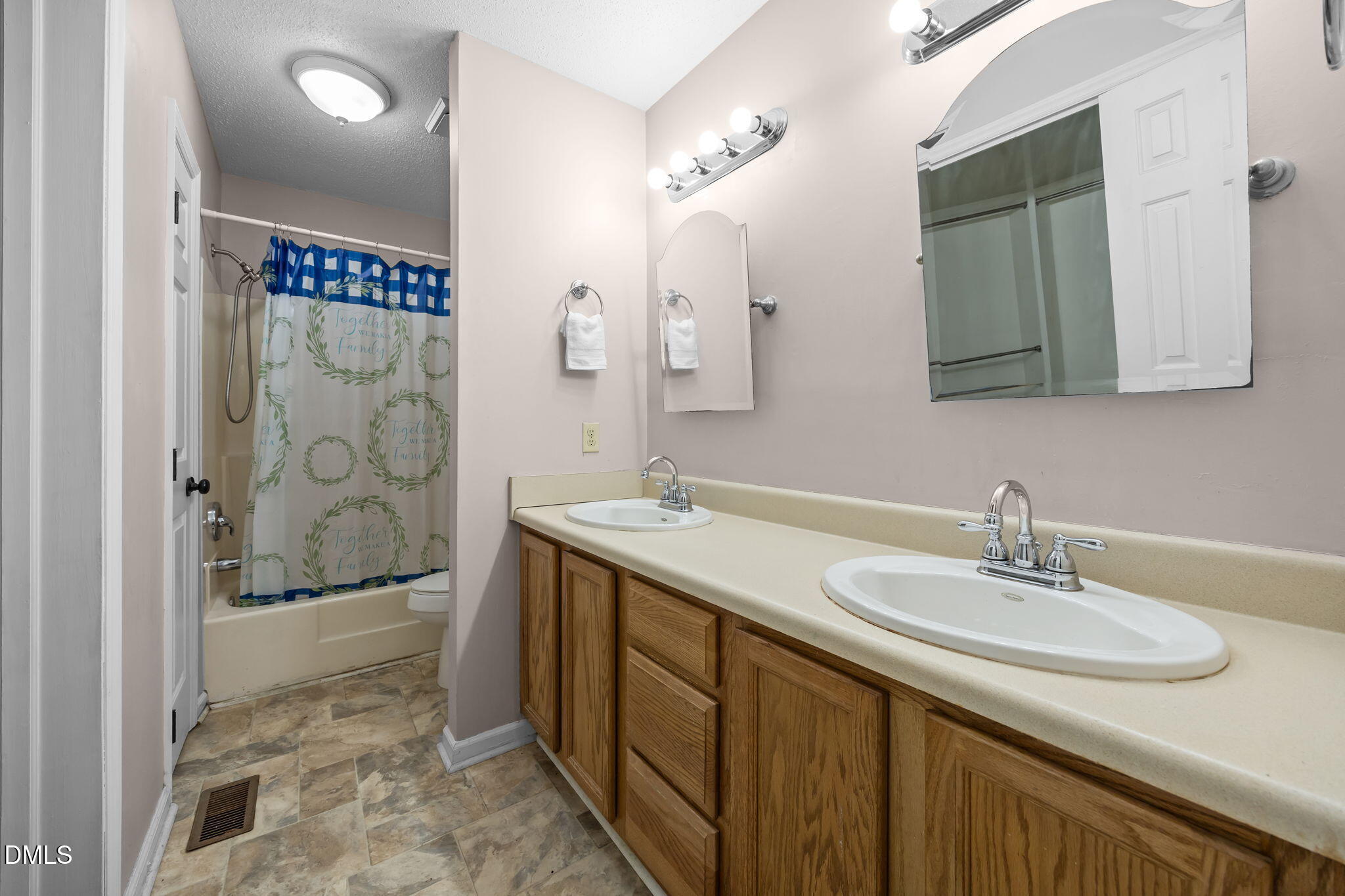 135 Boldleaf Court Cary, NC 27513 - Photo 14 of 27 a bathroom with a sink a mirror and a shower