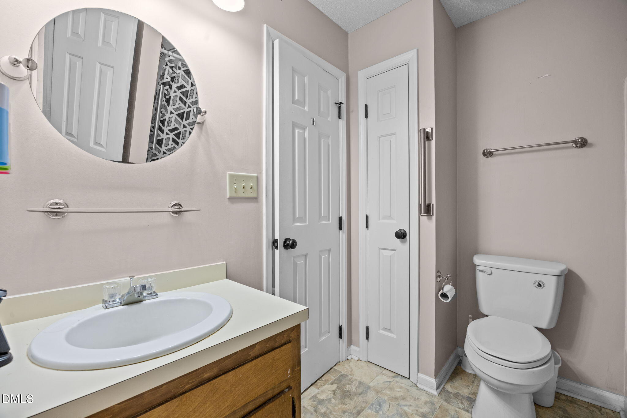 135 Boldleaf Court Cary, NC 27513 - Photo 18 of 27 a bathroom with a sink toilet and mirror