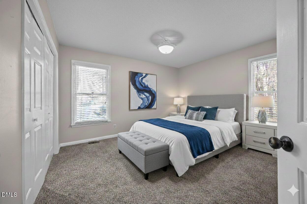 135 Boldleaf Court Cary, NC 27513 - Photo 21 of 34 a spacious bedroom with a bed and a window