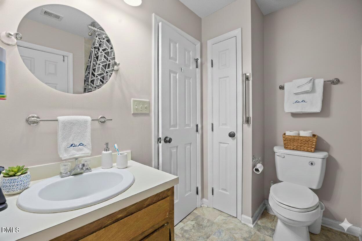 135 Boldleaf Court Cary, NC 27513 - Photo 24 of 34 a bathroom with a toilet sink and mirror