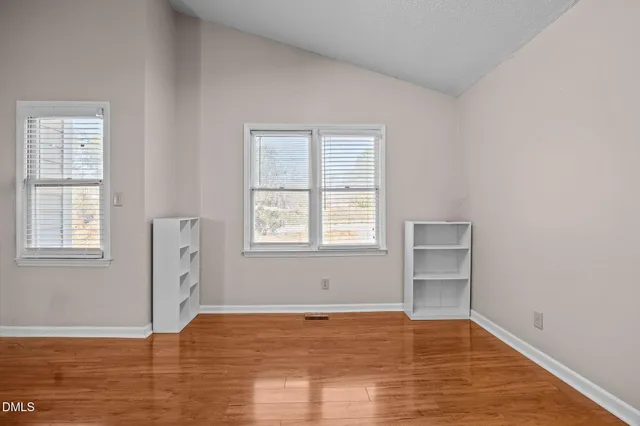 a view of a room with furniture and wooden floor