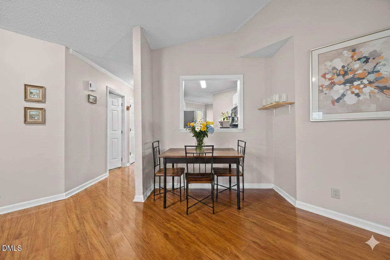 135 Boldleaf Court Cary, NC 27513 - Photo 8 of 34 a view of a dining room with furniture and wooden floor