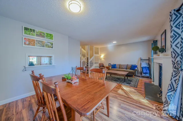 a living room with furniture and a dining table