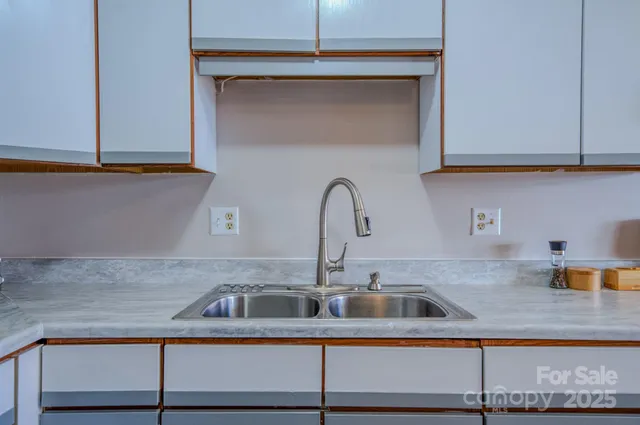 a kitchen with a sink and cabinets