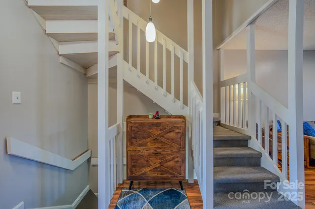 a view of entryway with wooden floor and stairs
