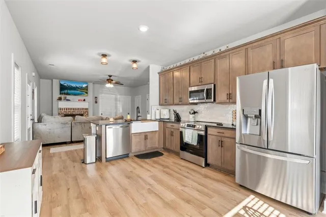 a kitchen with refrigerator a microwave and white cabinets