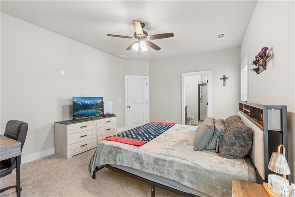 2522 Honeysuckle Lane Temple, GA 30179 - Photo 21 of 43 a bedroom with a bed and a flat screen tv