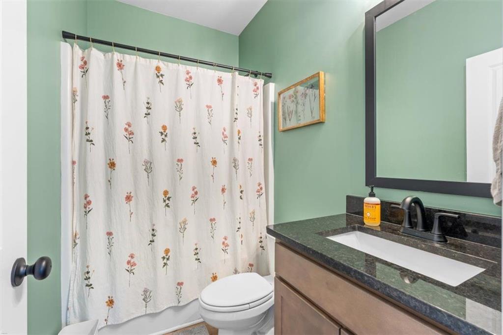 2522 Honeysuckle Lane Temple, GA 30179 - Photo 28 of 43 a bathroom with a granite countertop sink toilet and shower