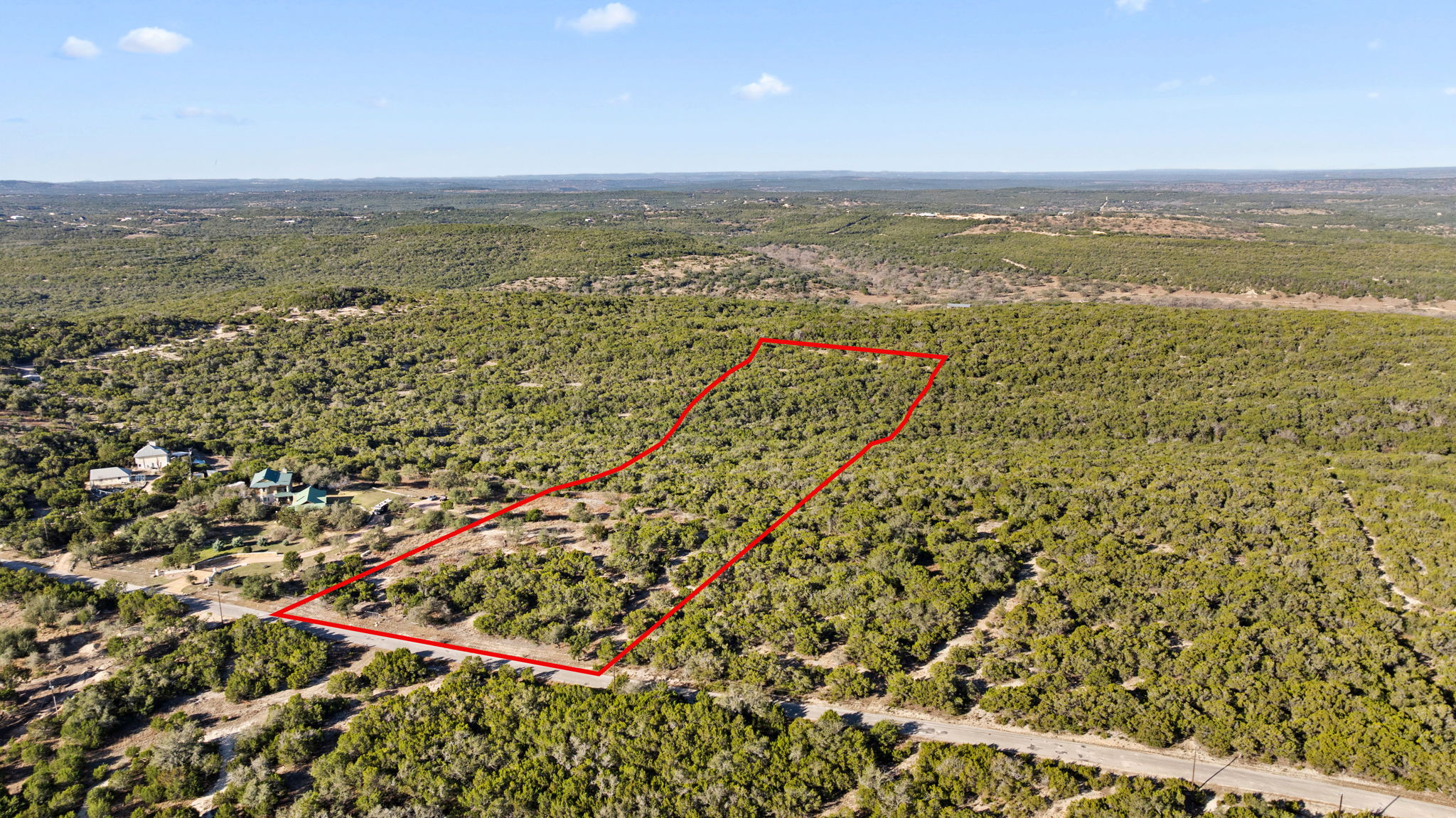 A sweeping aerial view reveals a vast expanse of verdant, undeveloped land.
