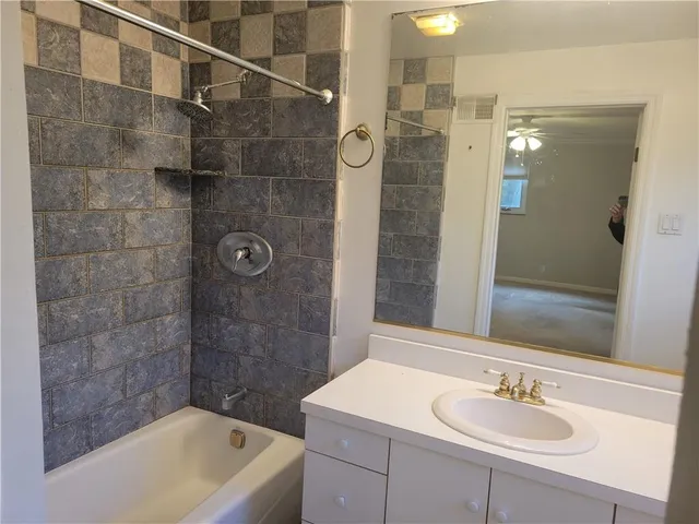 a bathroom with a sink shower and a bathtub