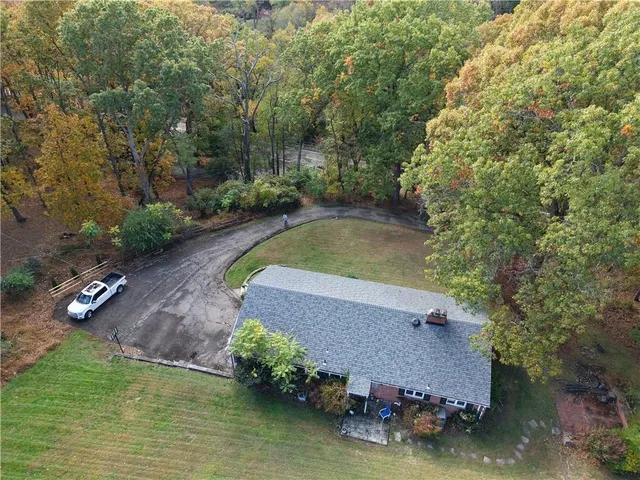 a view of wooden floor fire place and refrigerator in a kitchen
