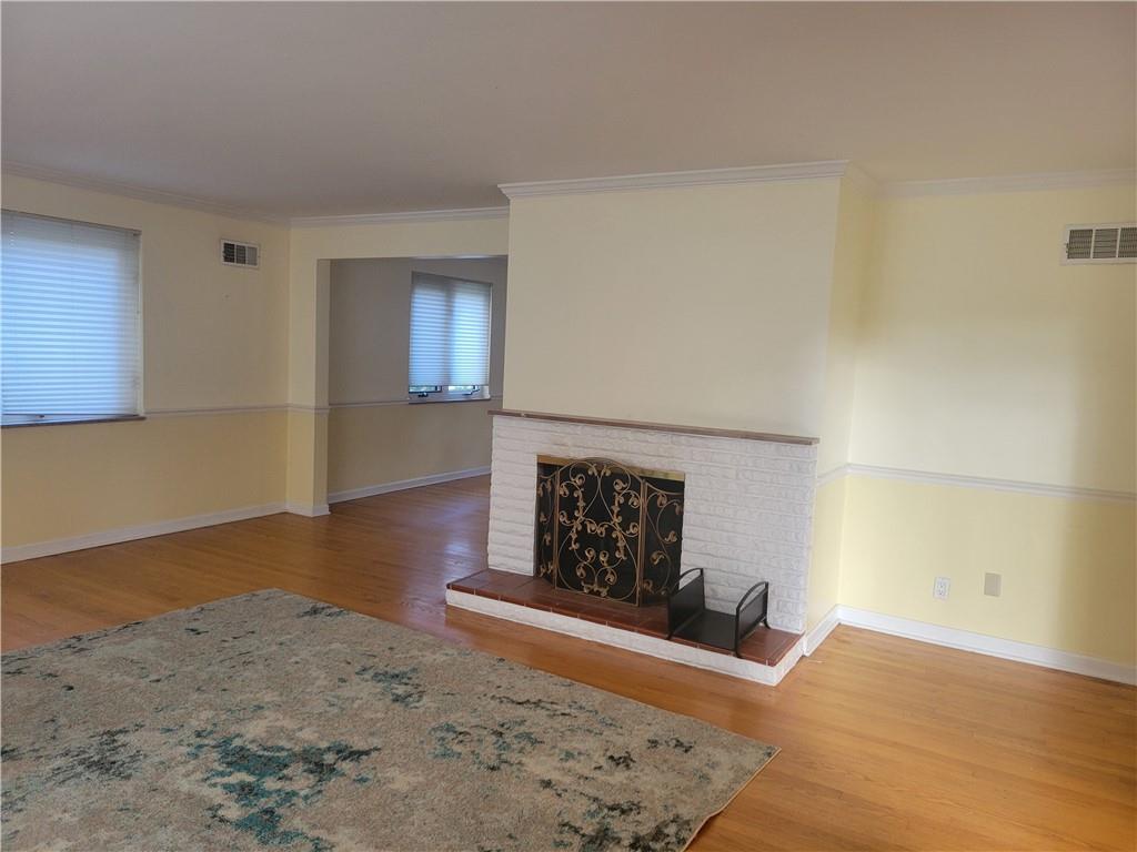 1260 Fox Chapel Road Pittsburgh, PA 15238 - Photo 25 of 29 a view of wooden floor fire place and refrigerator in a kitchen