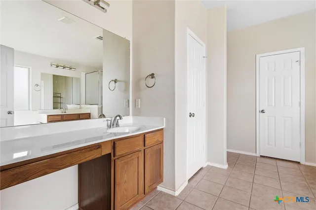 a bathroom with a sink a mirror and a shower