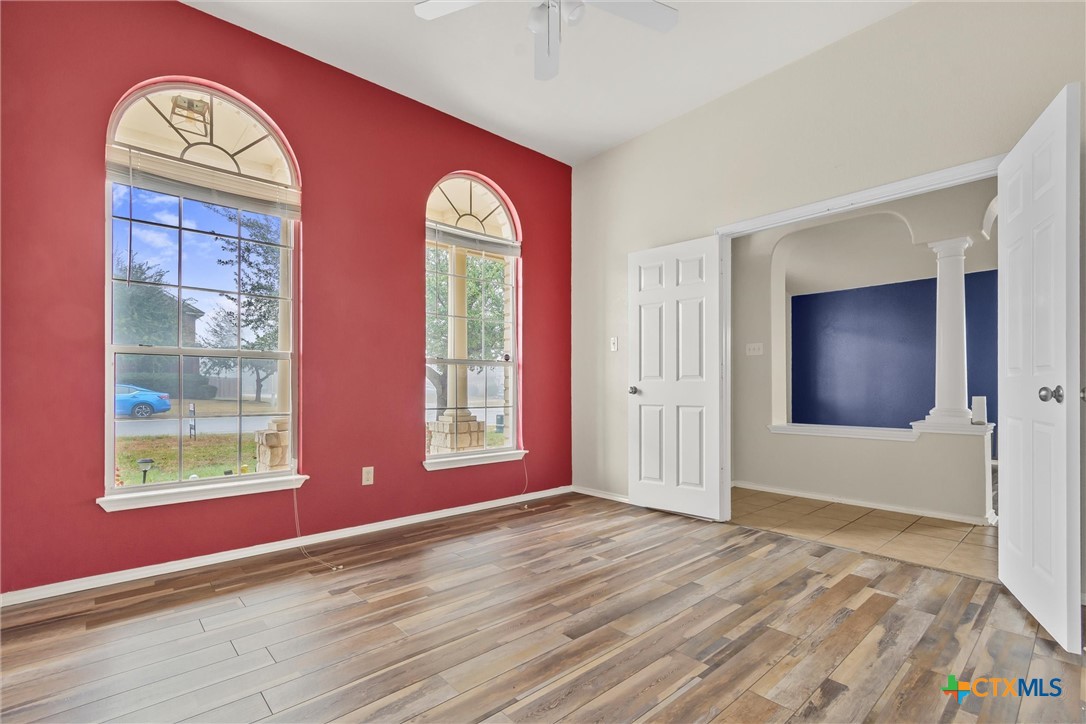 200 Memory Lane Harker Heights, TX 76548 - Photo 6 of 27 an empty room with windows closet and chandelier fan