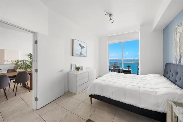 a bedroom with a bed and a chair