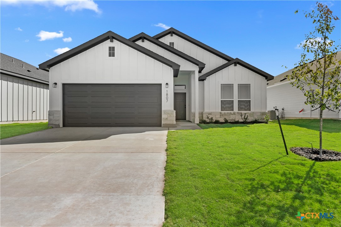 a front view of a house with a yard and garage
