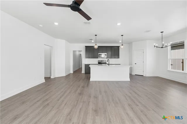 a view of kitchen with sink and wooden floor