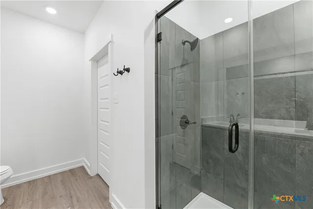a bathroom with a double vanity sink a mirror and a bathtub