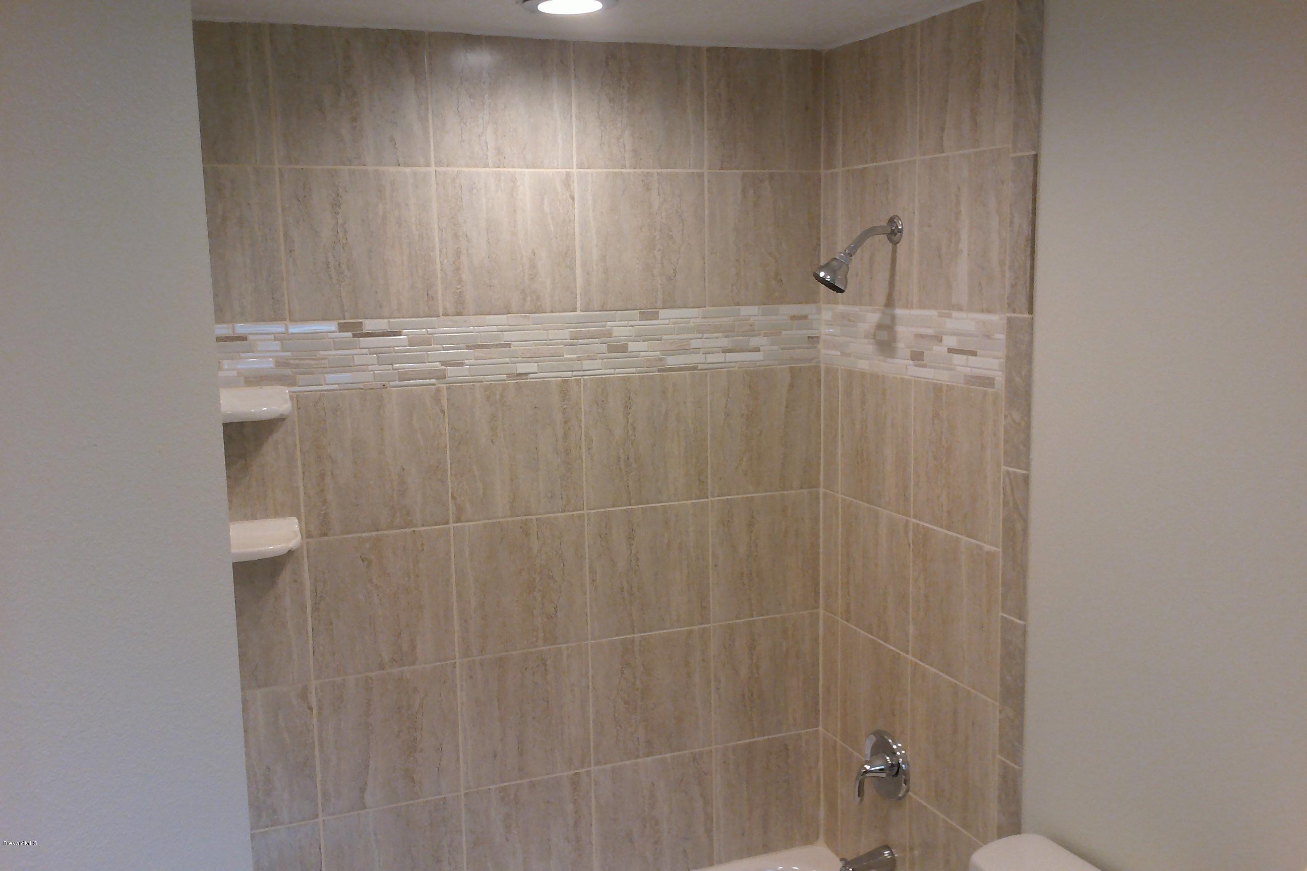 7401 Ester Road Cocoa, FL 32927 - Photo 27 of 41 New tiled shower in master bathroom