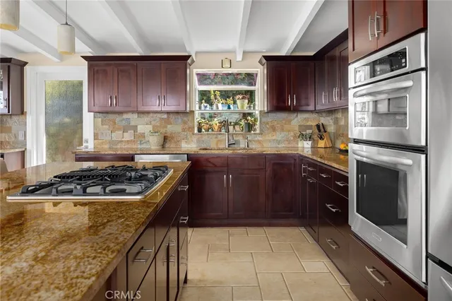 a kitchen with granite countertop stainless steel appliances and cabinets