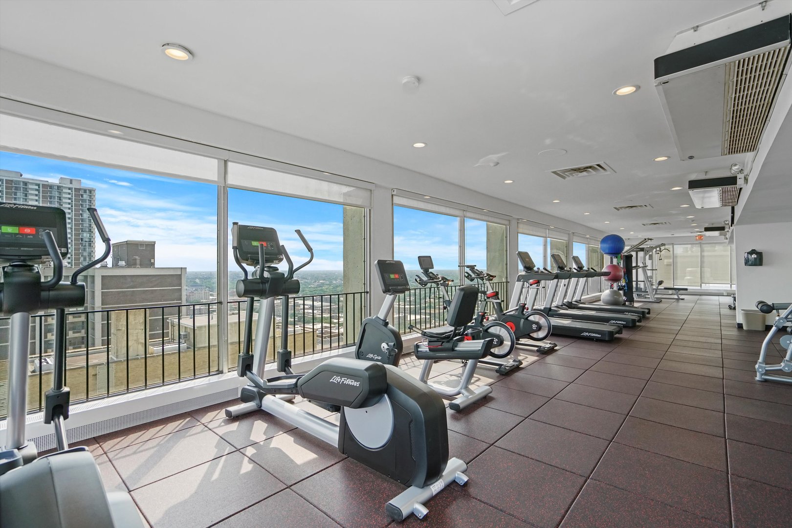 6171 North Sheridan Road, Unit 1401 Chicago, IL 60660 - Photo 18 of 29 a living room with lots of furniture and a chandelier