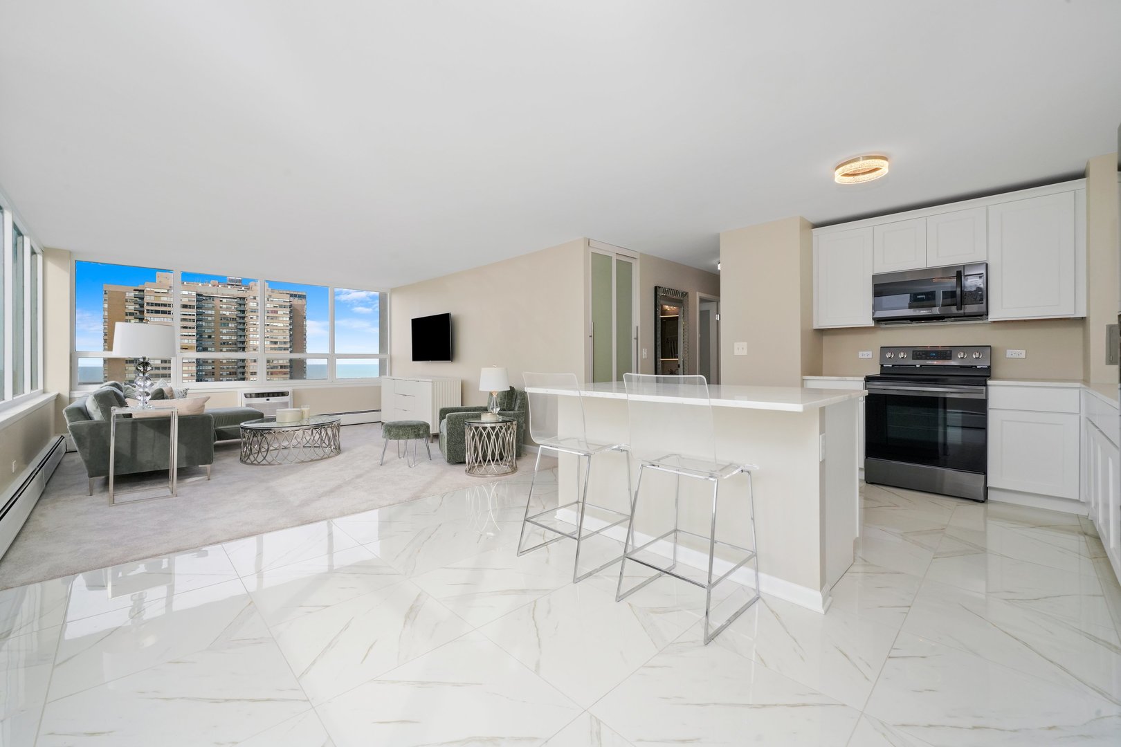 6171 North Sheridan Road, Unit 1401 Chicago, IL 60660 - Photo 3 of 29 a living room with stainless steel appliances kitchen island granite countertop furniture and a view of kitchen