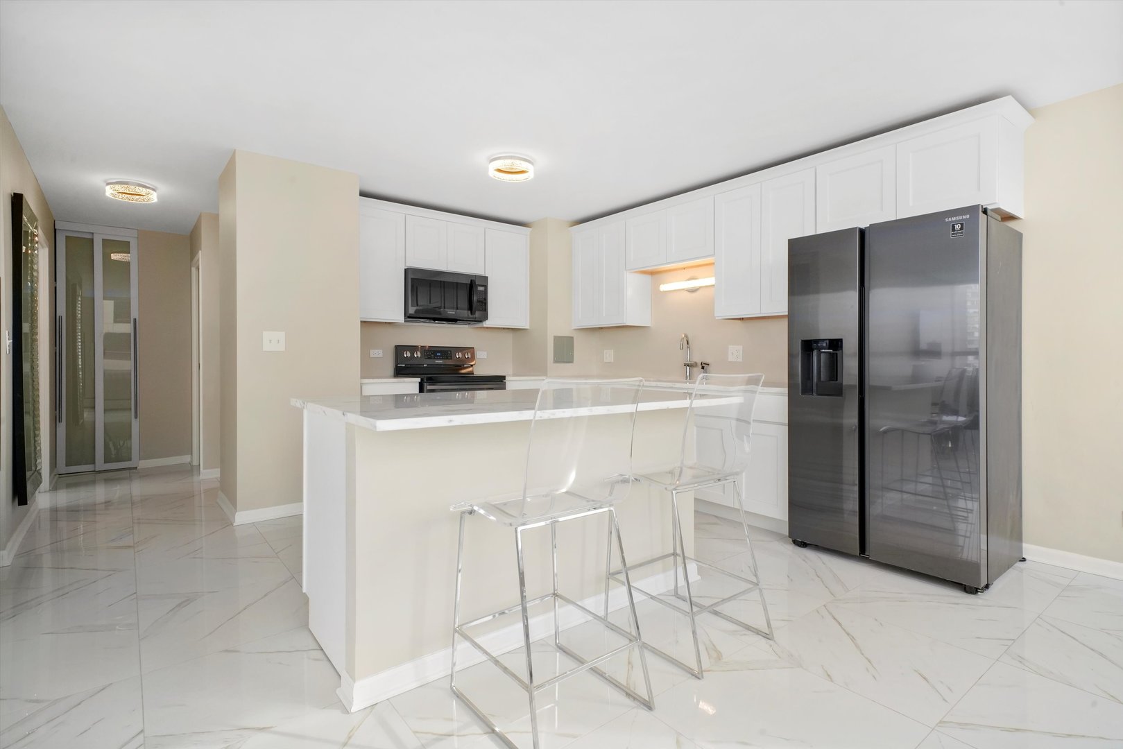 6171 North Sheridan Road, Unit 1401 Chicago, IL 60660 - Photo 4 of 29 a kitchen with stainless steel appliances granite countertop a refrigerator and a stove top oven