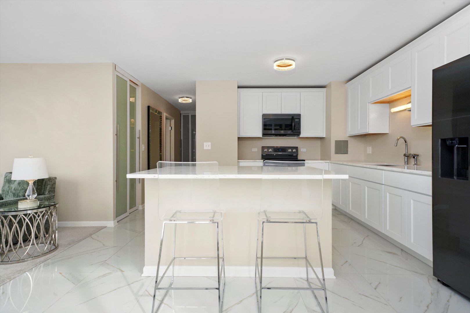 6171 North Sheridan Road, Unit 1401 Chicago, IL 60660 - Photo 5 of 29 a kitchen with cabinets a sink and a stove