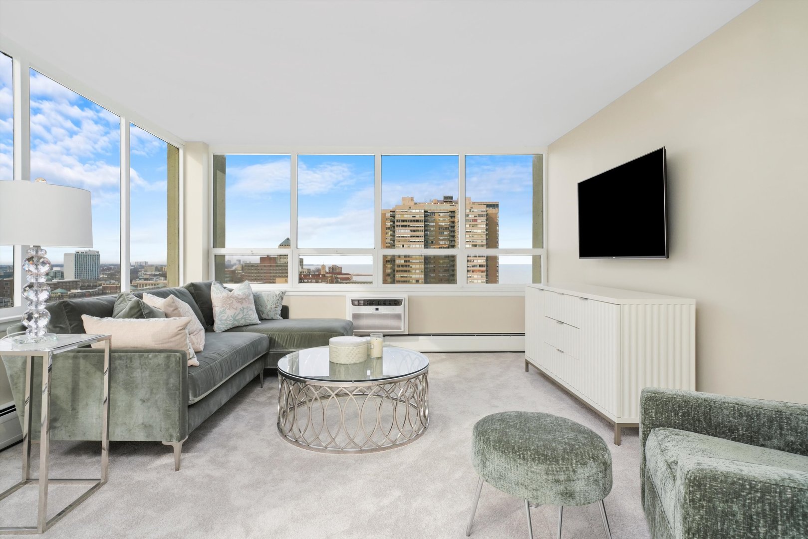 6171 North Sheridan Road, Unit 1401 Chicago, IL 60660 - Photo 10 of 29 a living room with furniture and a flat screen tv