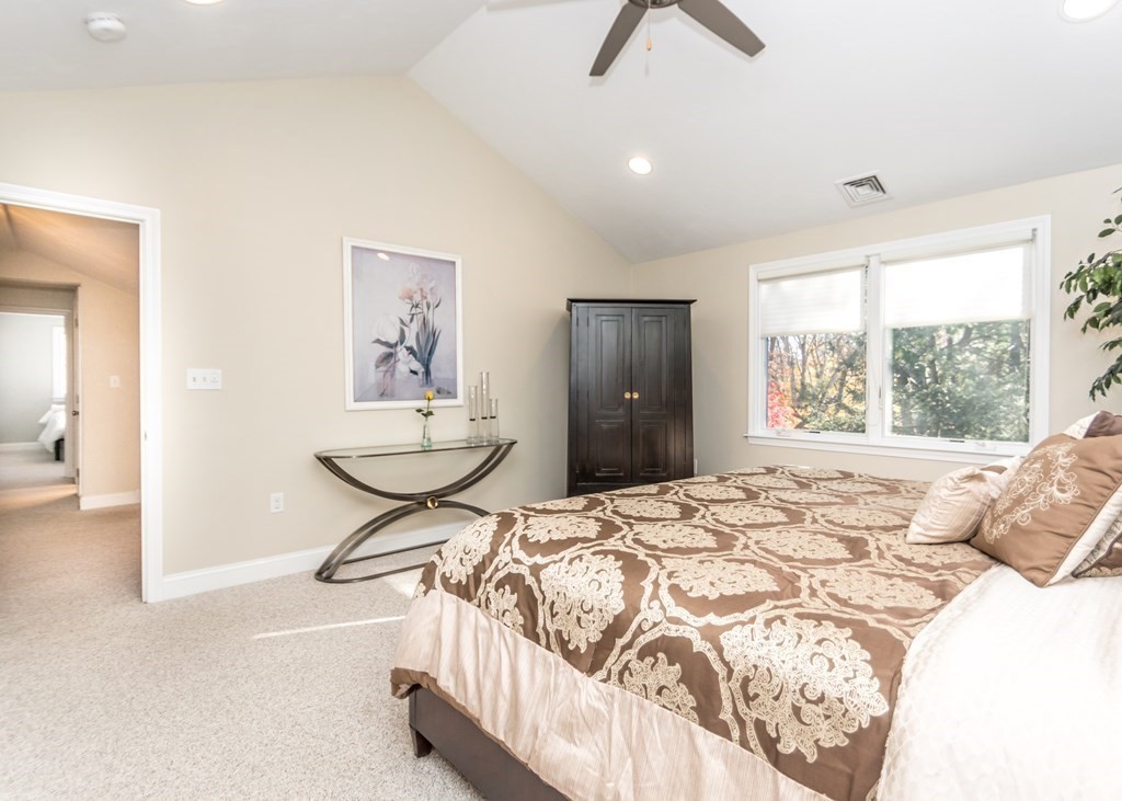 60 Pershing Road Needham, MA 02494 - Photo 14 of 30 a bedroom with a bed and a chandelier