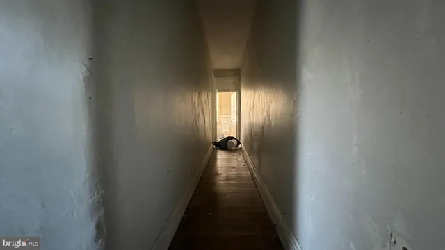 a view of a hallway with wooden shelves